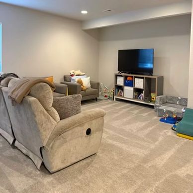 Cozy living room with beige recliner and TV area.