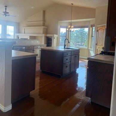 Spacious kitchen with wooden cabinets and a central island.