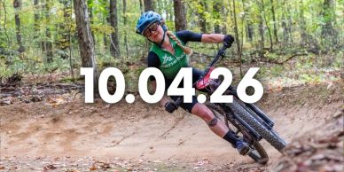 Person mountain biking on a forest trail.