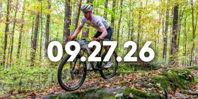 Mountain biker jumping over rocks in a forest.