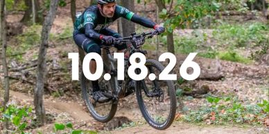 Cyclist jumps on forest trail with date overlay 10.18.26.