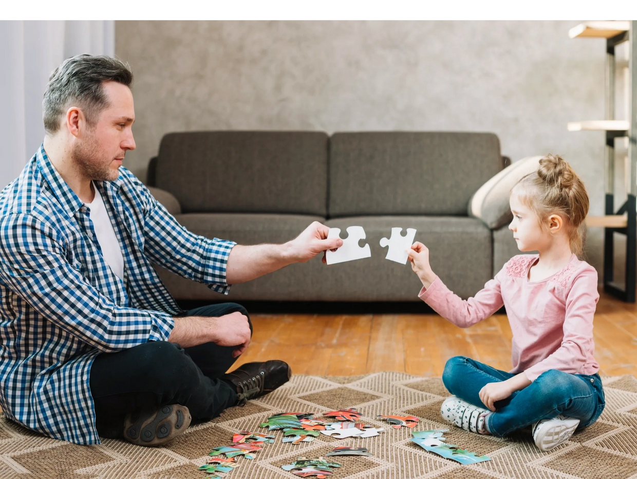 Father and daughter playing with puzzle