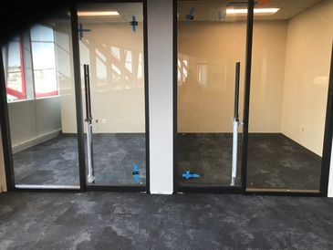 A clean office partition and glass doors leading to modern office look. Switch light privacy glass available. 