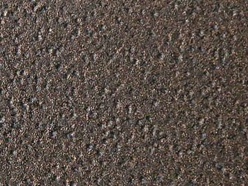 Close-up of rough, textured brown surface with small granular details.