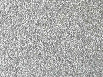 Close-up of a textured white wall surface.