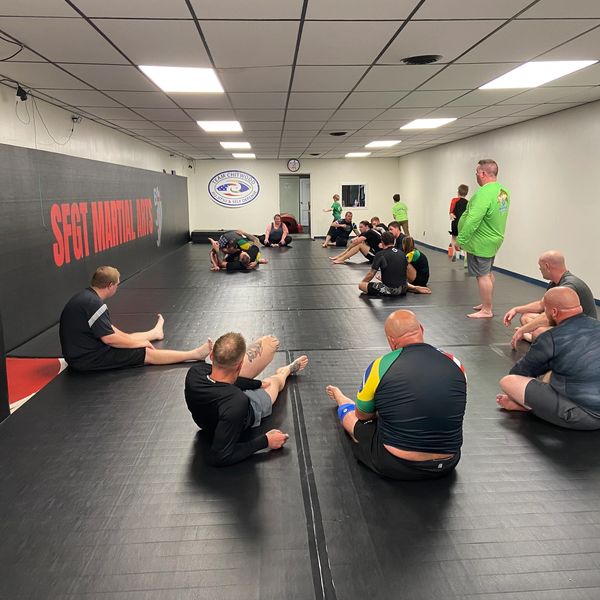 Adult students learning self-defense during BJJ class at SFGT Martial Arts.