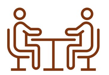 Two people sitting across a table.