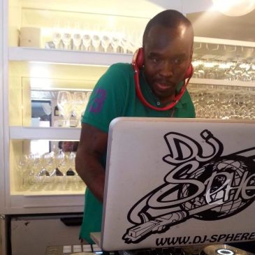 DJ mixing music with headphones around his neck.