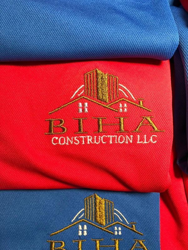 Embroidered construction company logos on shirts.