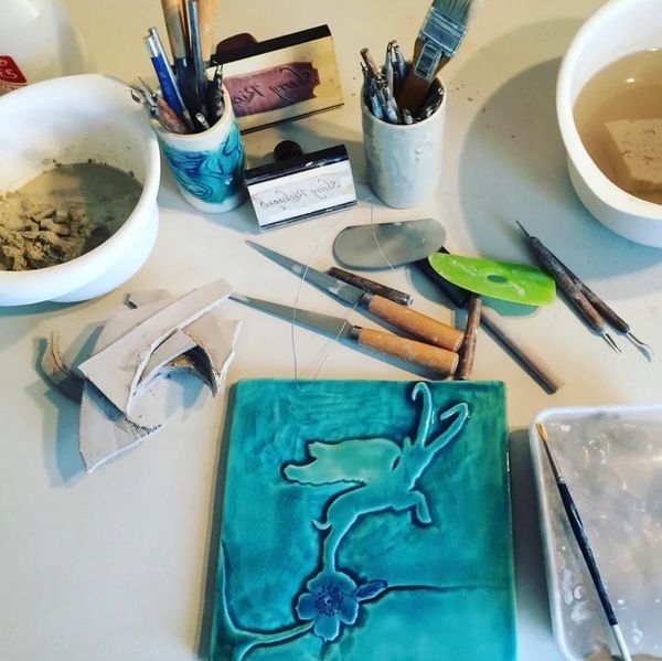 turquoise hand carved art tile in design studio where my handmade ceramics are created