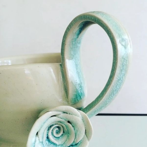handmade ceramic tea cup with turquoise handle and handmade rose 