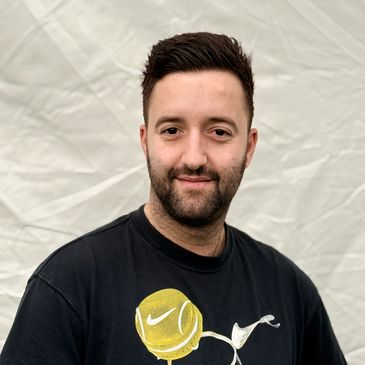 Man with a beard wearing a black Nike t-shirt.