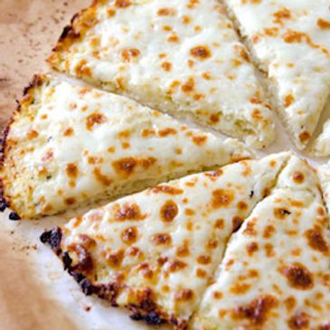 Cheesy white pizza slices with golden brown spots.