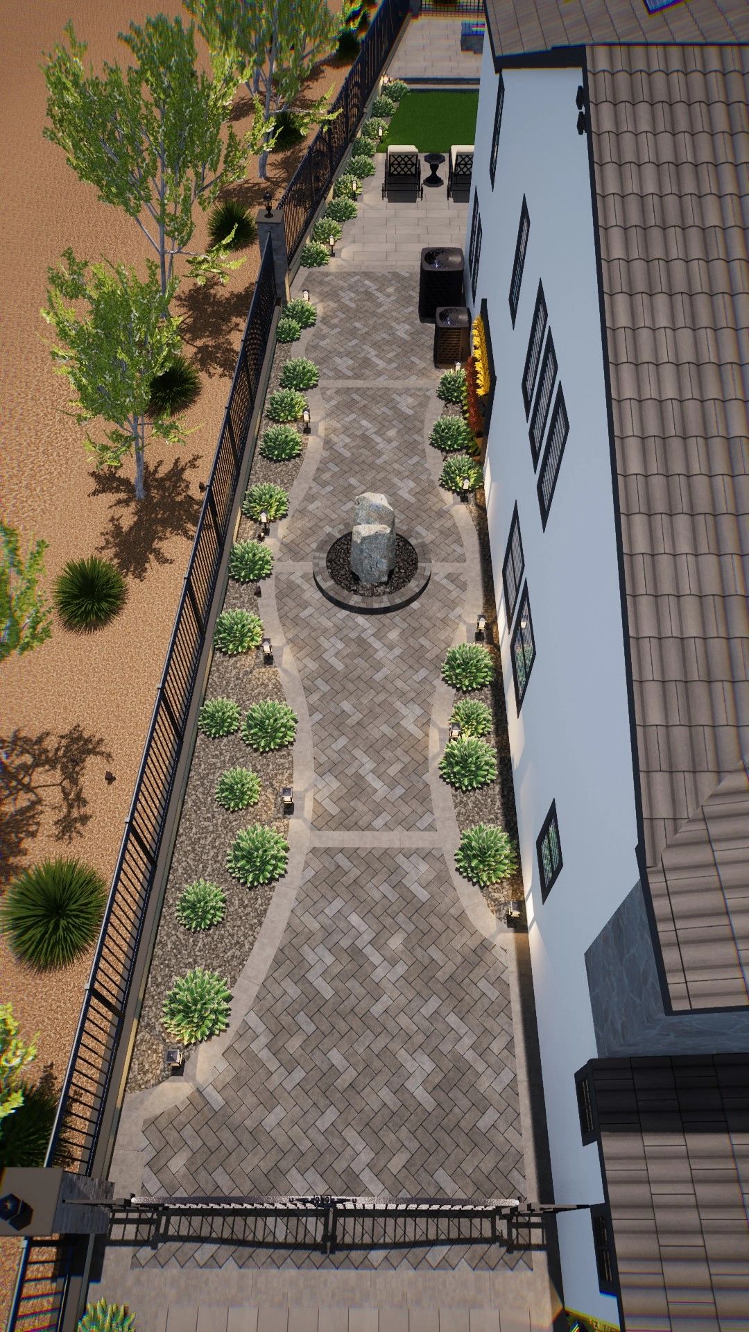 Concrete pavers along the side of property, with basalt rock water feature. 