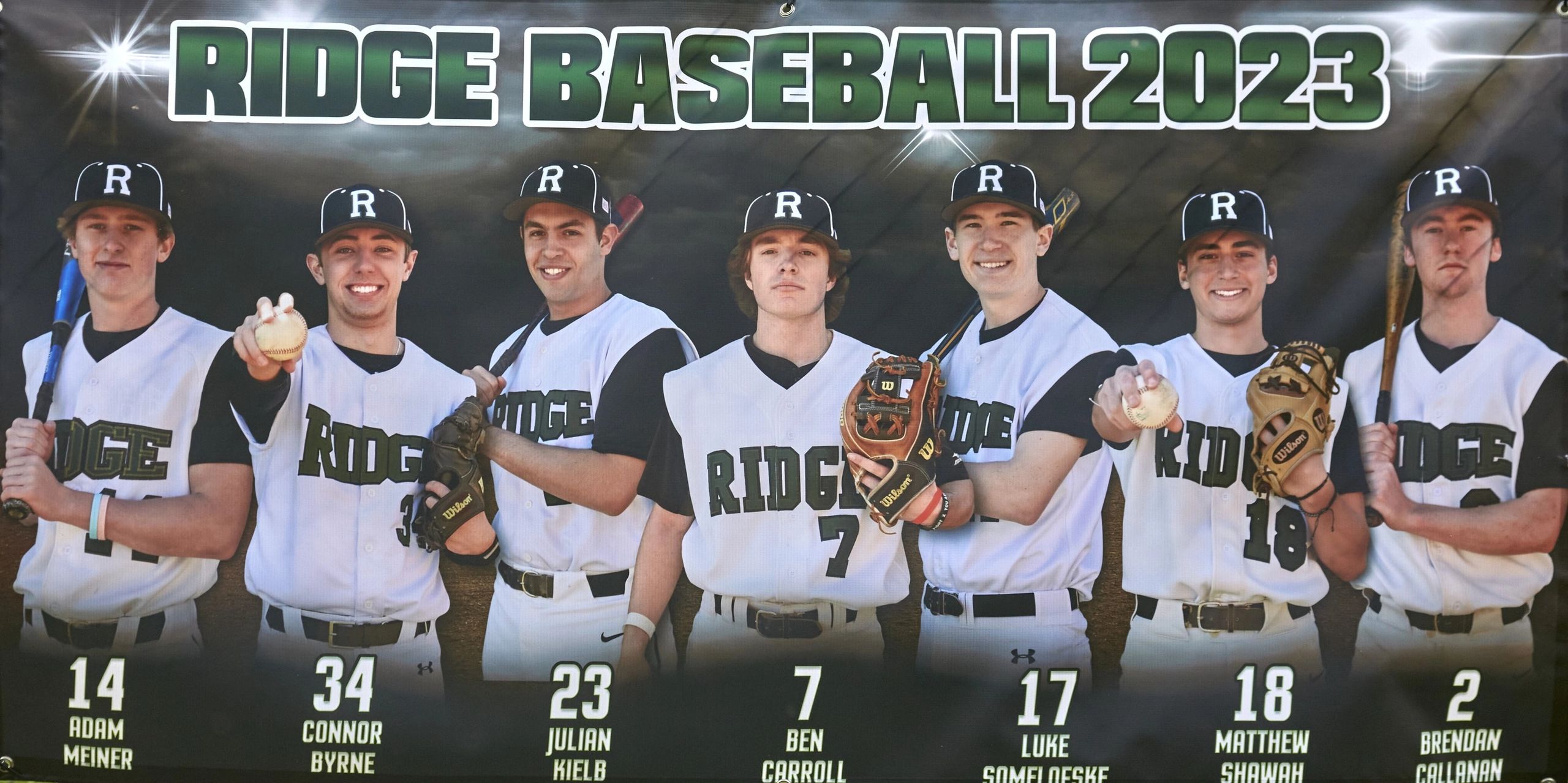 Seven Ridge Baseball players pose for a 2023 team banner.