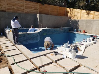 Pool crew working on a pool interior during a remodel
