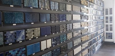 Pool tile sample displays lining the Islander Pool & Spa showroom wall