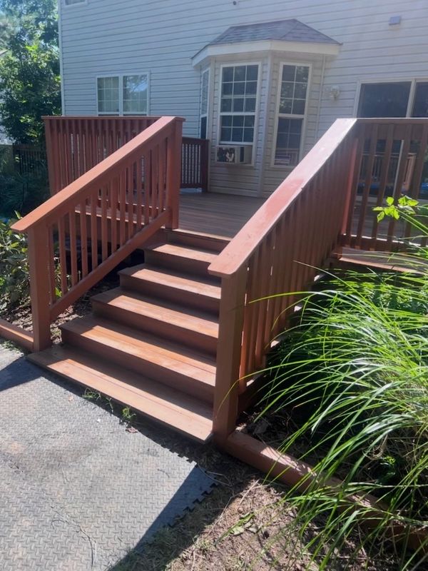 Wooden deck stairs leading to a porch area.