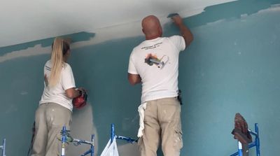 Jack and Caitlin Dalton painting the true Hilton hotel together