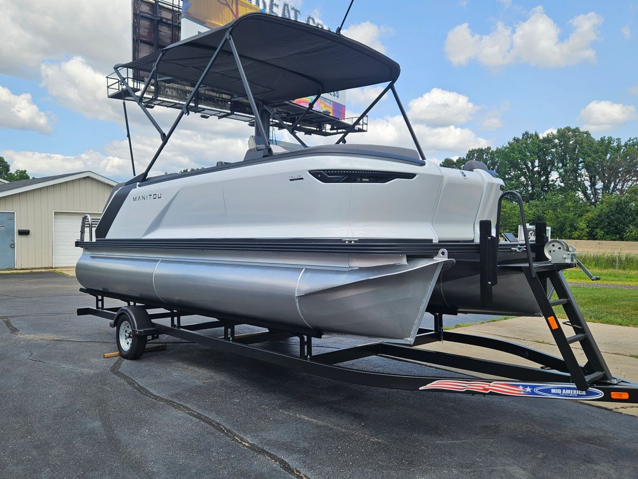 White pontoon boat on a trailer.
