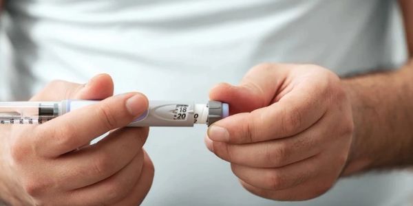 Person holding an insulin pen.
