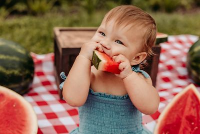 1 year old girl eating watermelon at her milestone photos