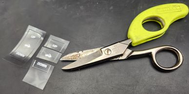 A pair of scissors and small labeled plastic bags.