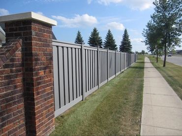 Modern backyard with dark wooden fence and trimmed green grass