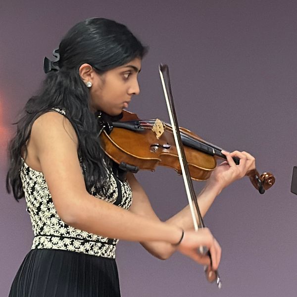 Young woman intensely playing the violin.