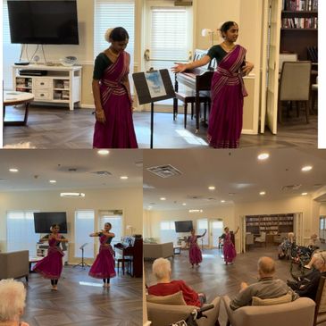 Two women in traditional attire performing a dance for an elderly audience indoors.