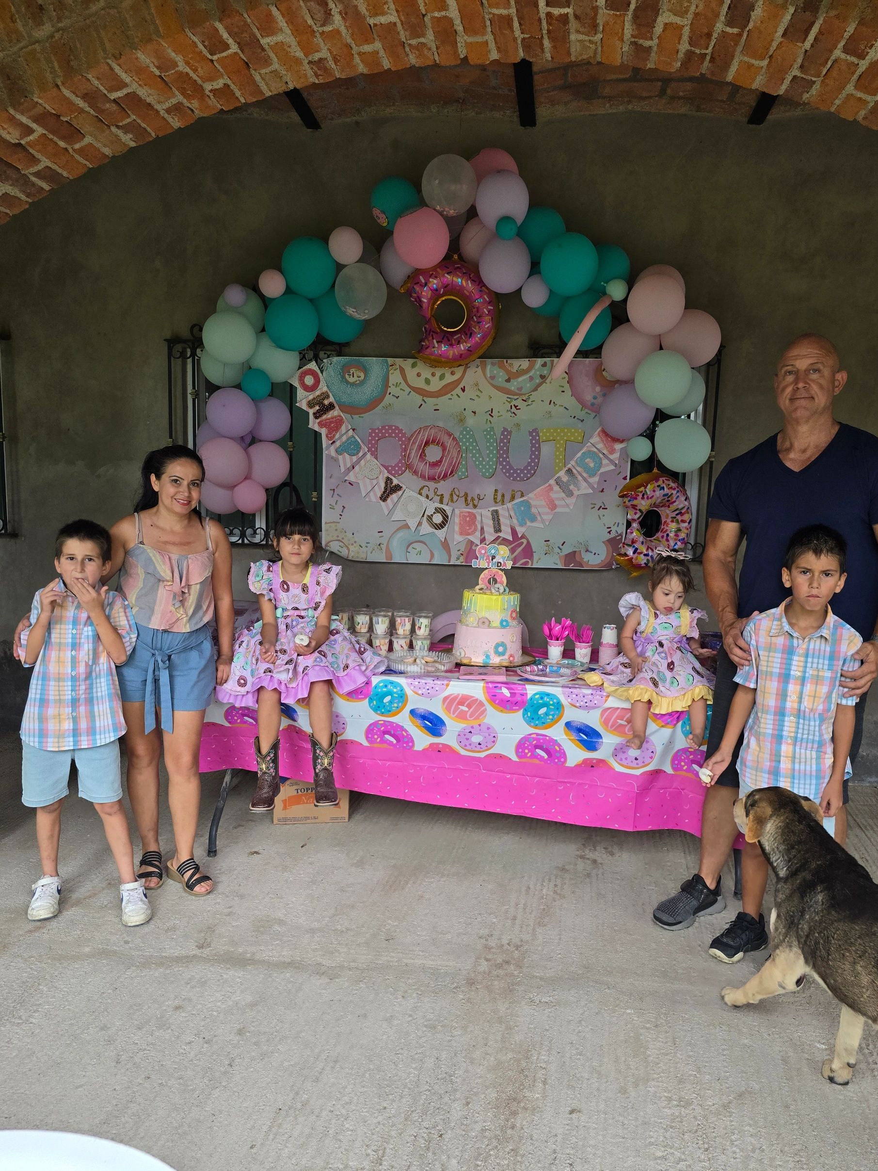 The Hill family, founders of Haul Squad, celebrating together at a family party with balloons.