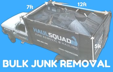 Haul Squad truck loaded with bulk junk for removal — furniture, boxes, and household clutter