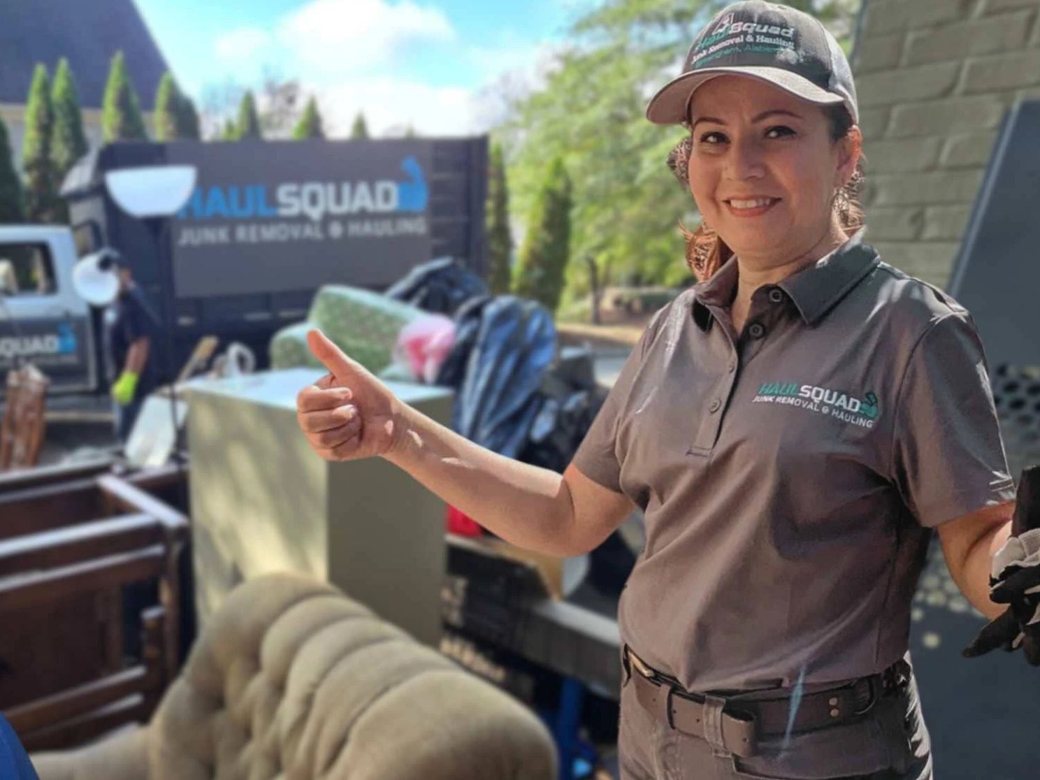 Haul Squad lifting a couch during junk removal in Mountain Brook