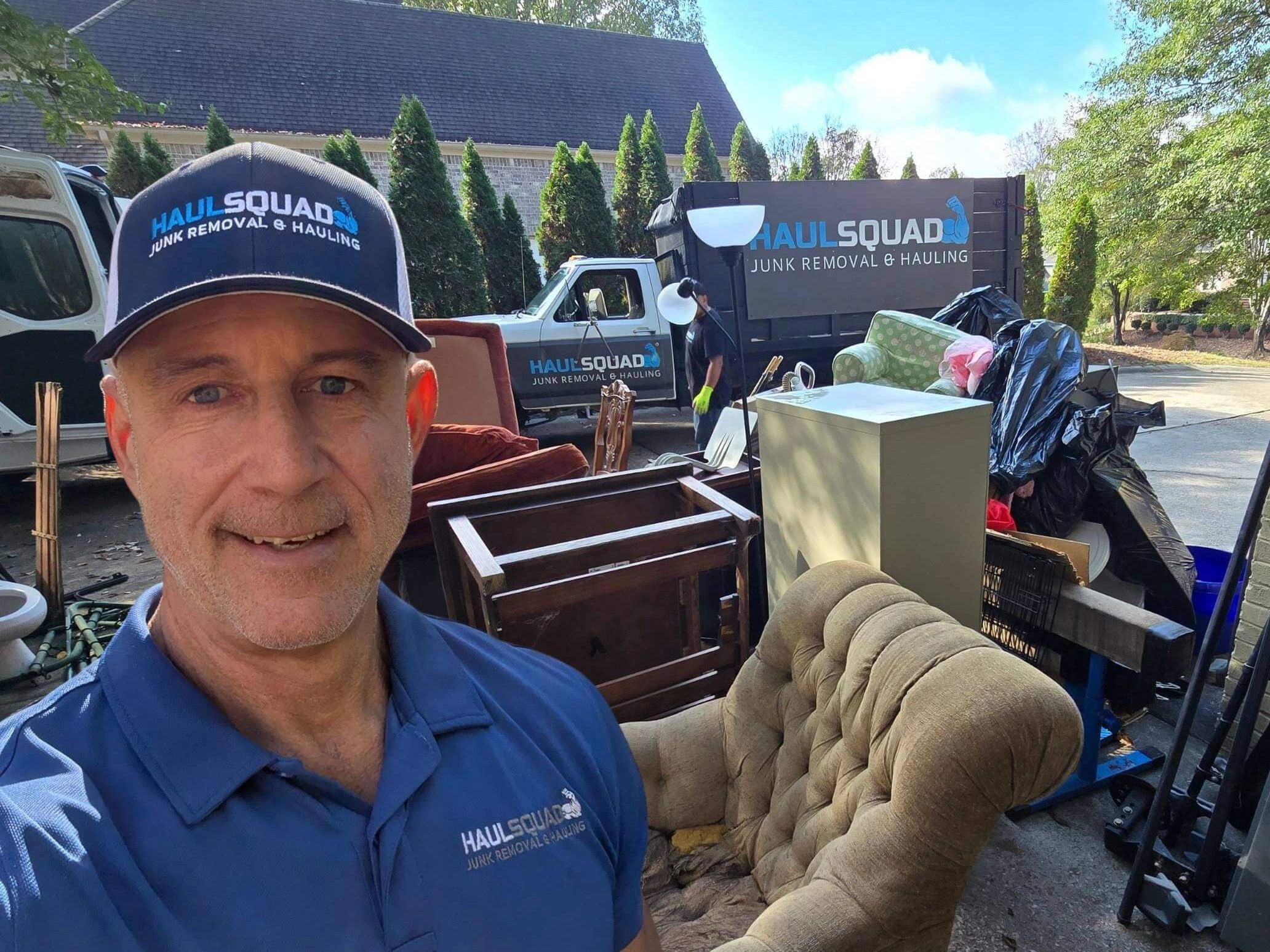 Haul Squad lifting pink couch during junk removal in Pelham, AL –fast, affordable, 5-star rated team