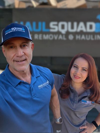 Friendly Haul Squad owner stands proudly by junk hauling truck in scenic Mountain Brook driveway.