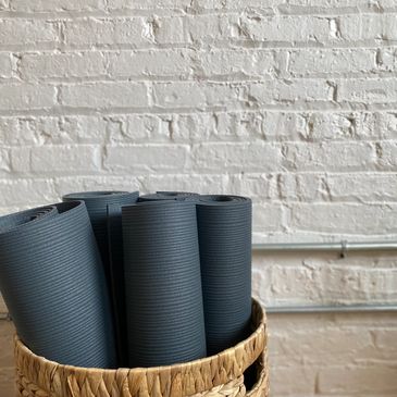 Basket of Manduka yoga mats