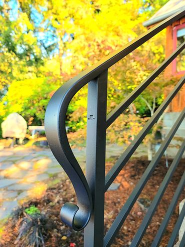 Hand-forged wrought iron guard railing with horizontal pickets by Primal Forge blacksmith shop