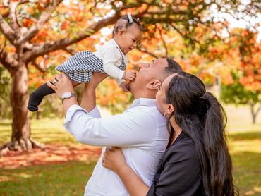 Happy family enjoying time together outdoors in autumn.