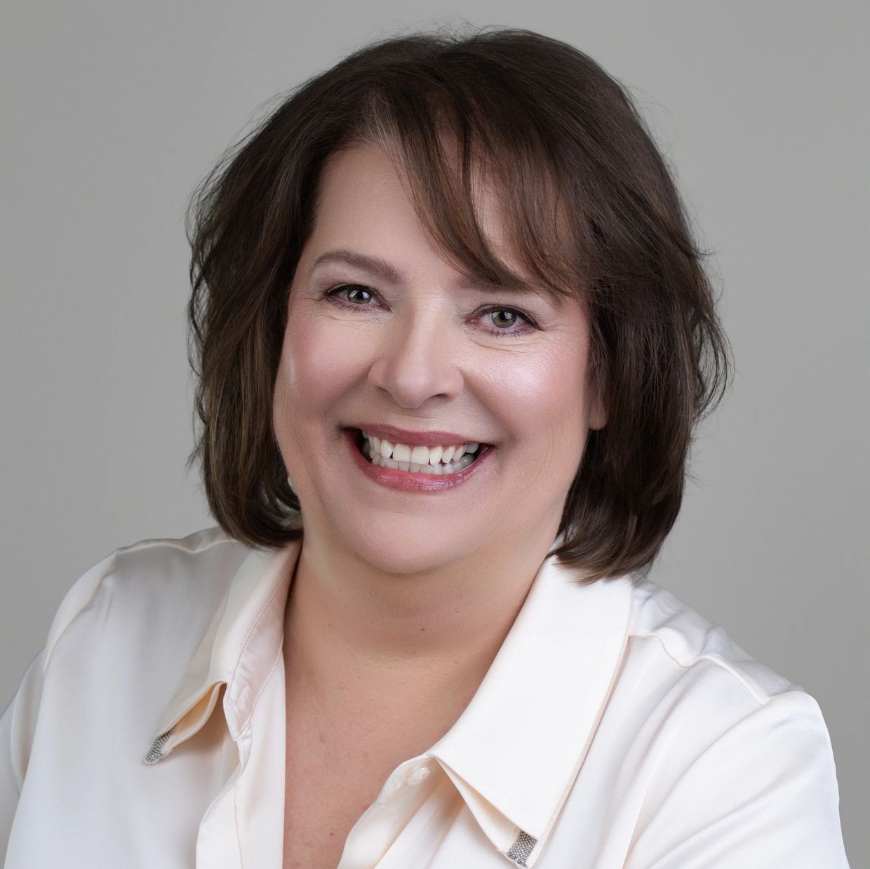 Smiling middle-aged woman with short brown hair.