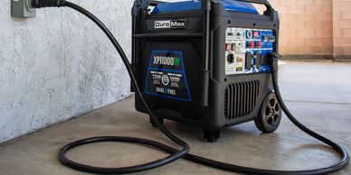 DuroMax XP11000iH generator connected to a home power outlet.