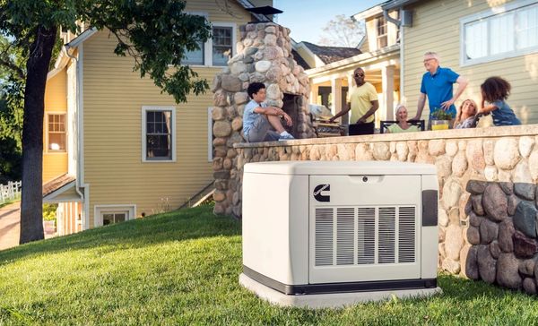 A family enjoys a sunny backyard with a Cummins generator nearby.
