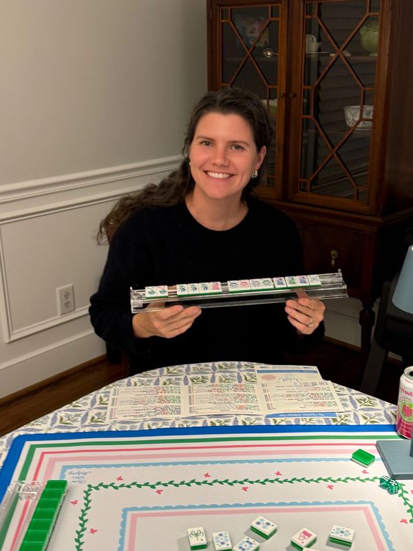 Young woman smiling after winning Mahjong