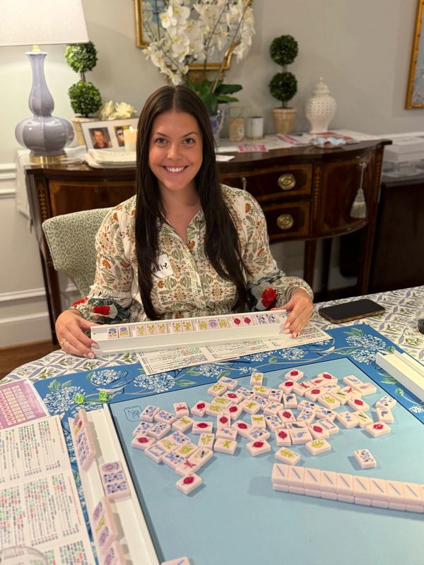 Young woman smiling after winning Mahjong