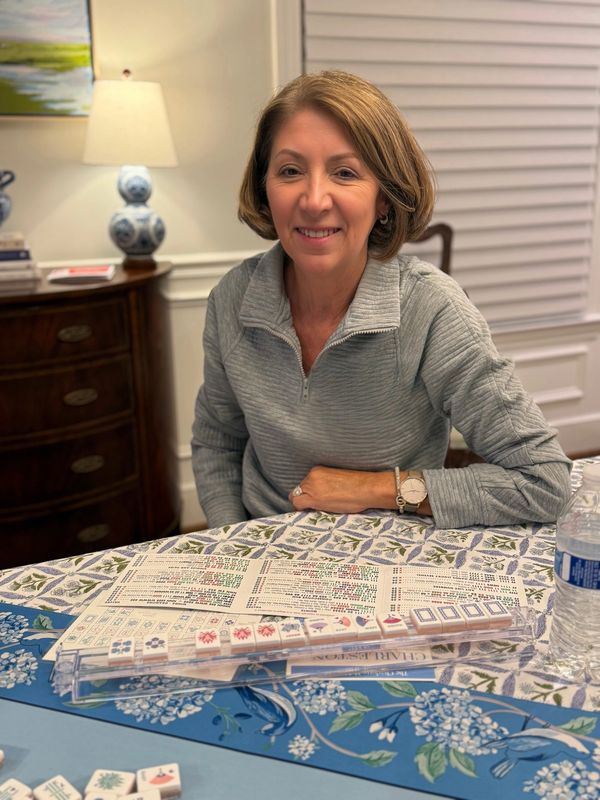 Young woman smiling after winning Mahjong