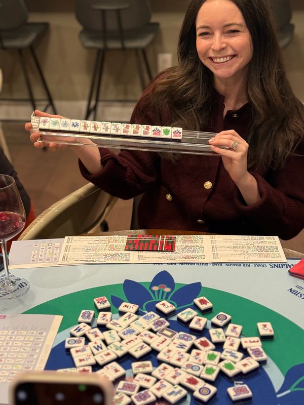 Young woman smiling after winning Mahjong