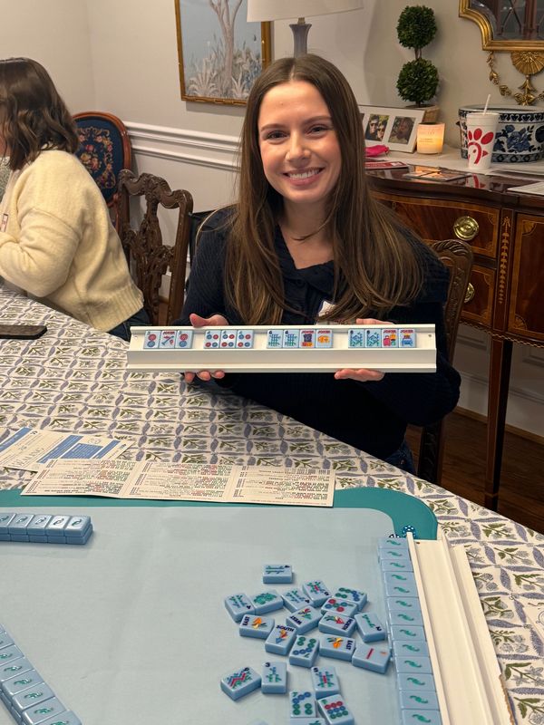 Young woman smiling after winning Mahjong