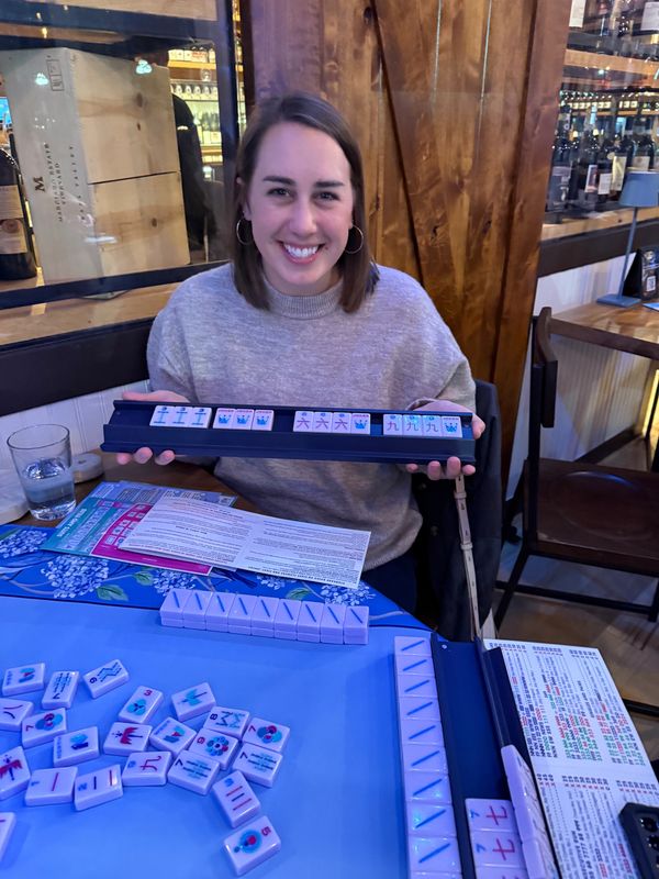 Young woman smiling after winning Mahjong