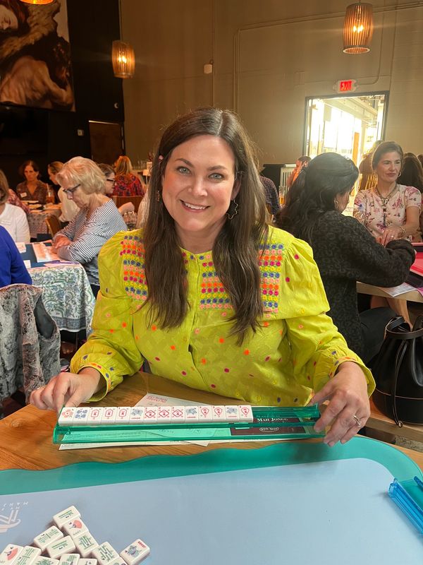 Young woman smiling after winning Mahjong