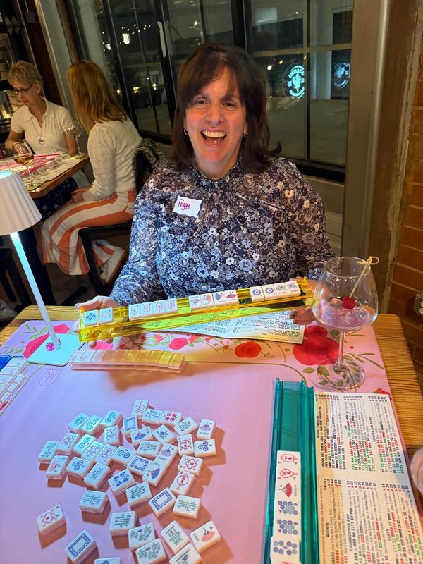 Young woman smiling after winning Mahjong