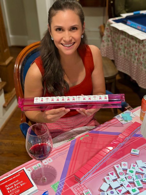 Young woman smiling after winning Mahjong